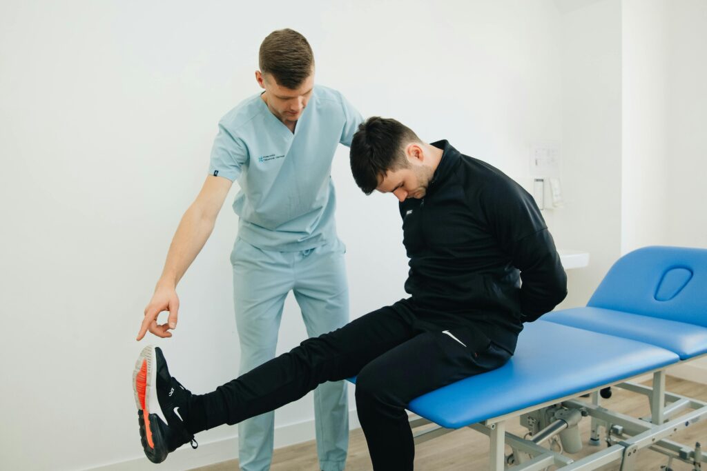 Physiotherapist instructing a patient on rehabilitation exercises in a clinic setting.